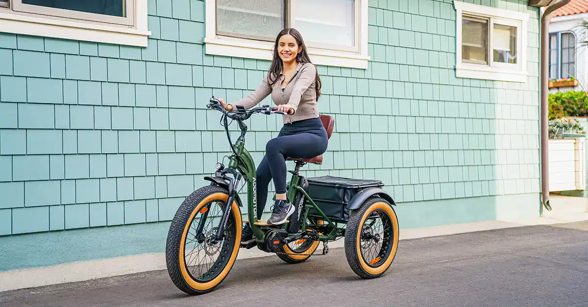 a woman is riding a 3-wheel electric bike